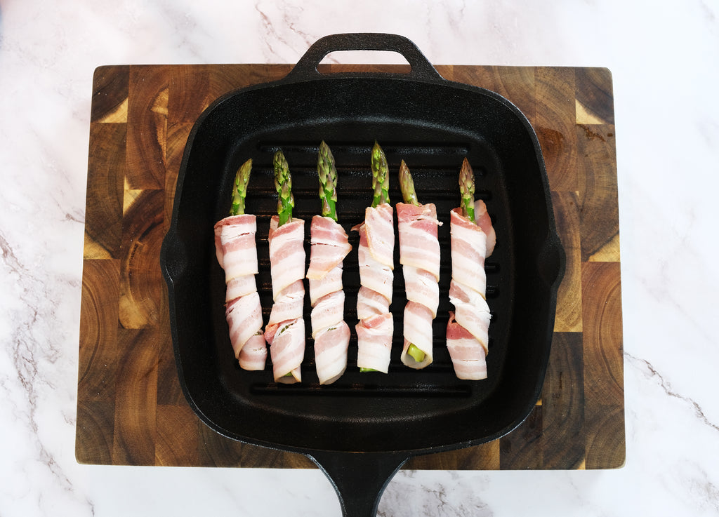 bacon wrapped asparagus in a cast iron grill pan