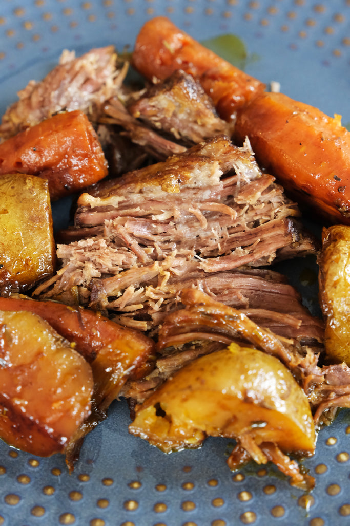 chuck roast served with carrots and potatoes