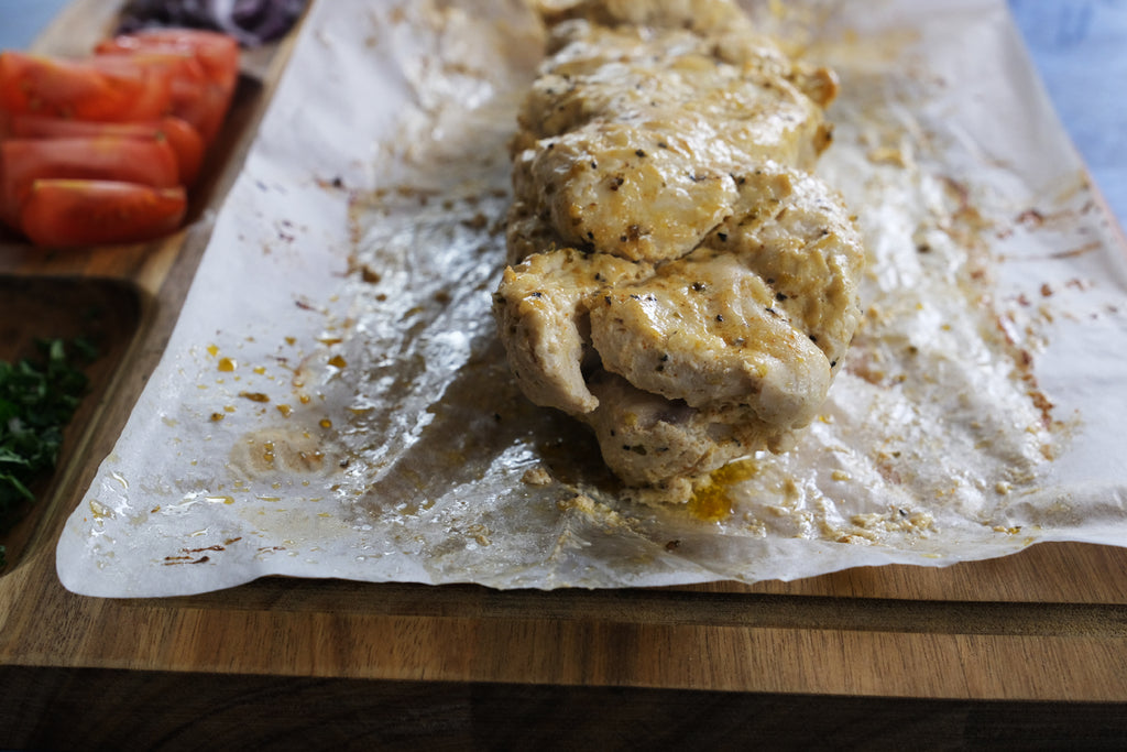 chicken gyros on a wooden cutting board