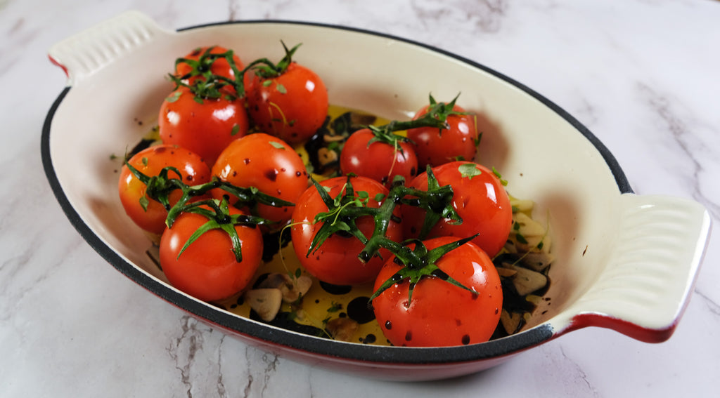 Roasted tomatoes in an emameled cast iron roasting pan