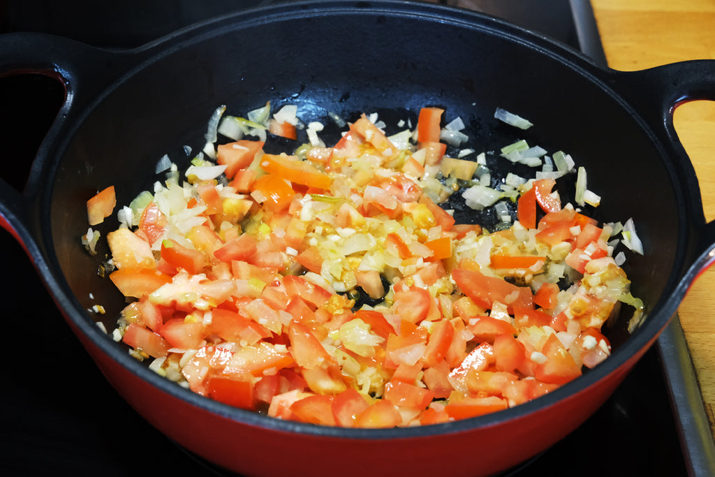 cooking vegetables in an enameled cast iron balti dish