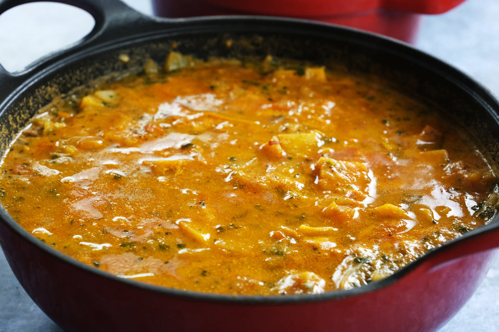 mafe with butternut squash in an enameled cast iron balti dish