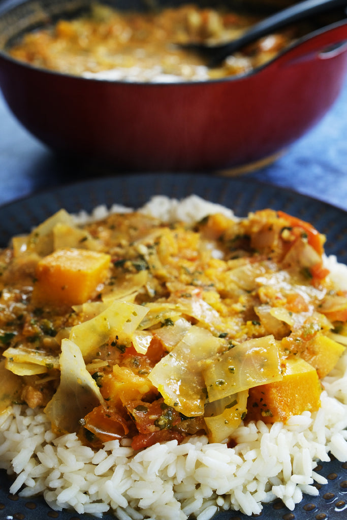 mafe with rice and an enameled balti dish in the background