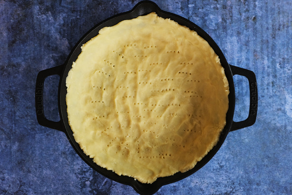 pie crust in a 10 inch cast iron skillet with loop handles