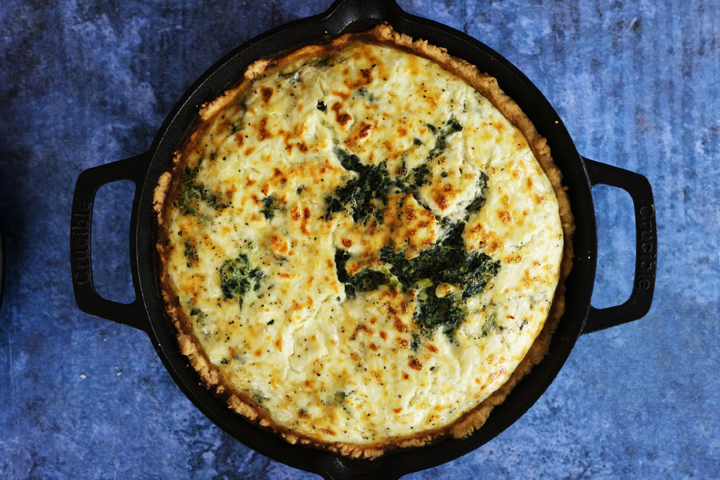 spinach pie baked in a cast iron skillet frying pan