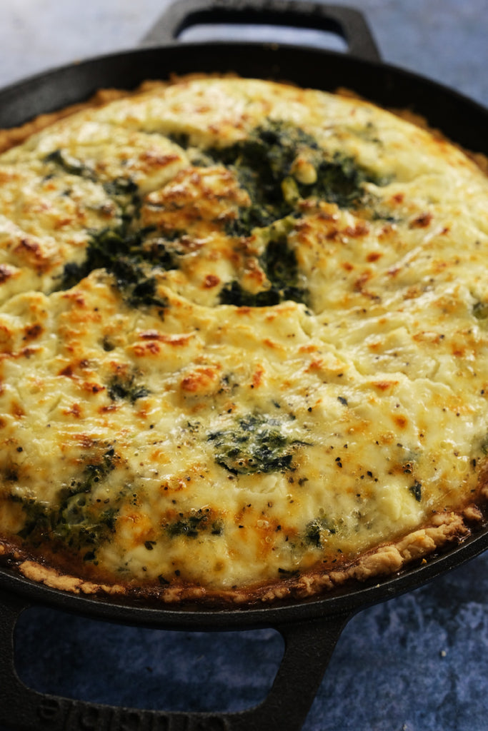 spinach and onion pie in a cast iron skillet frying pan