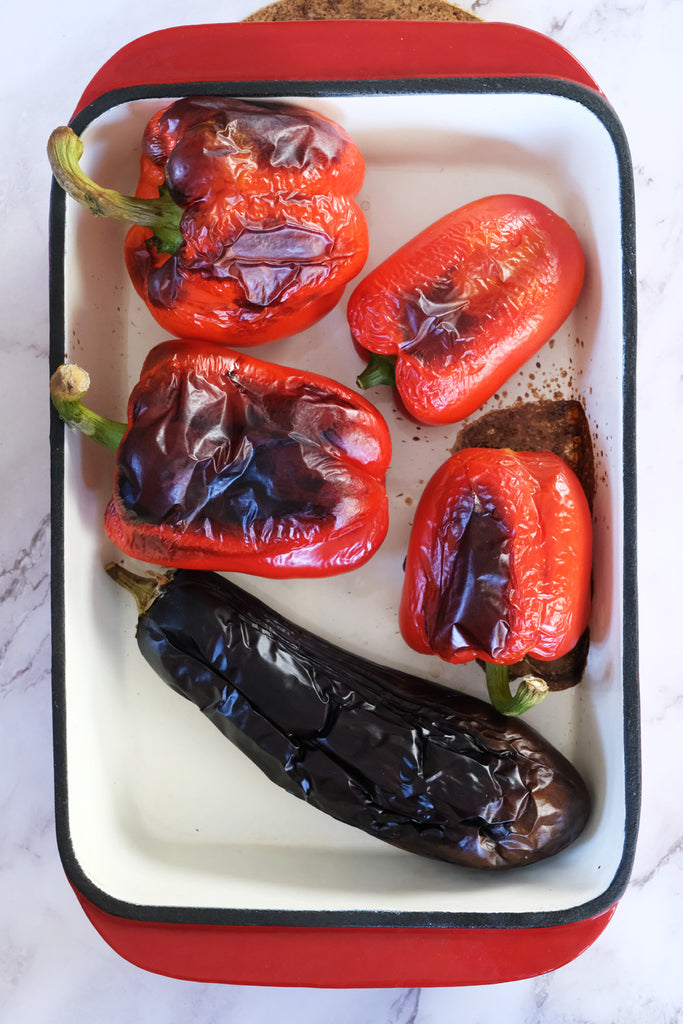 burned eggplant and bell peppers in a roasting pan