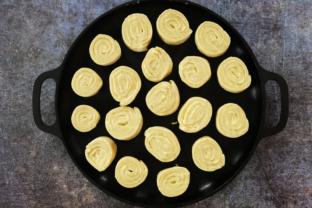 butter rolls on a cast iron pizza baking pan