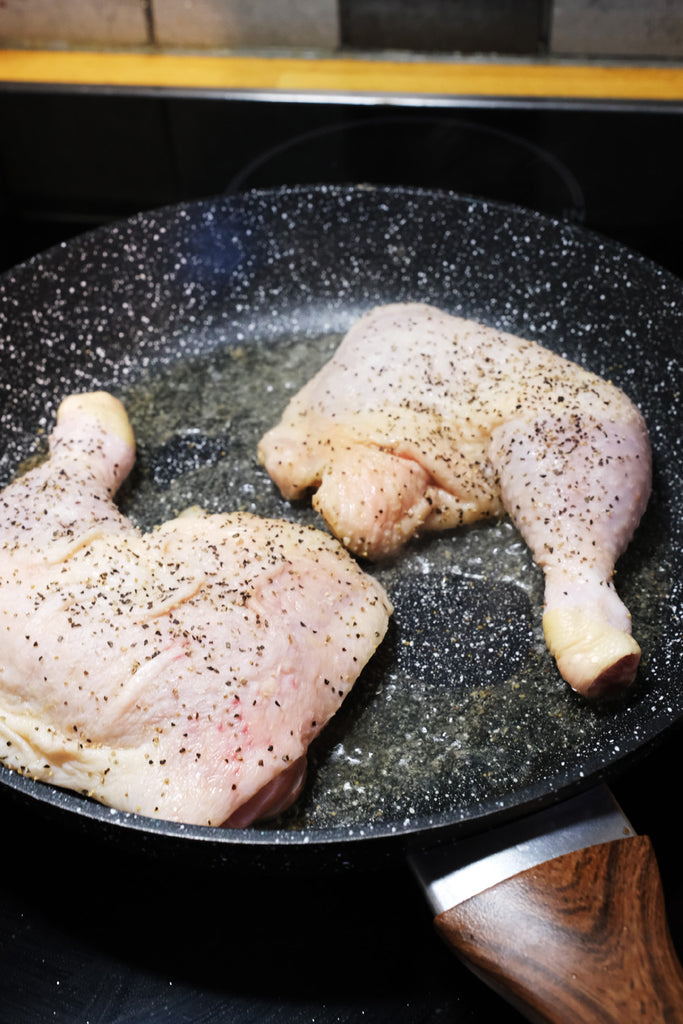 searing chicken in a frying pan