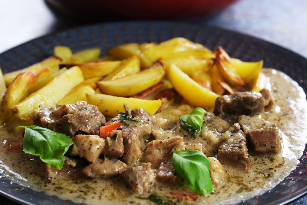 lamb stew topped with fresh basil