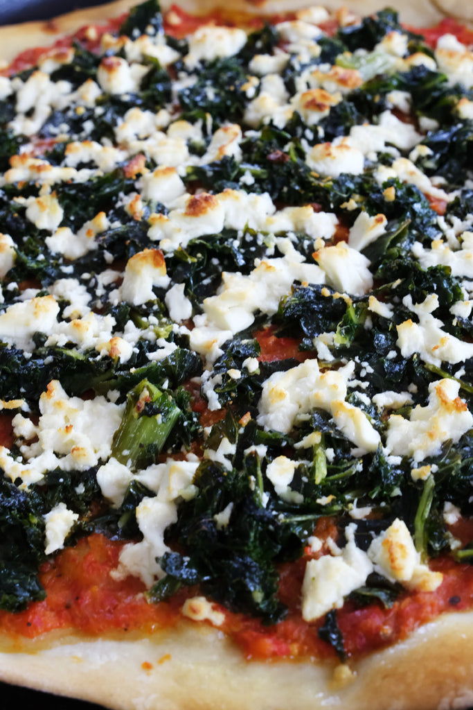 pizza with ajvar relish, kale and feta cheese