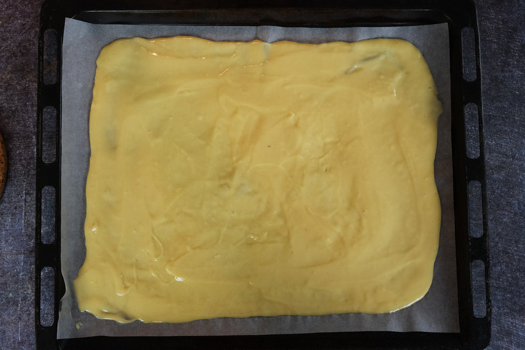 pancake batter spread on a sheet