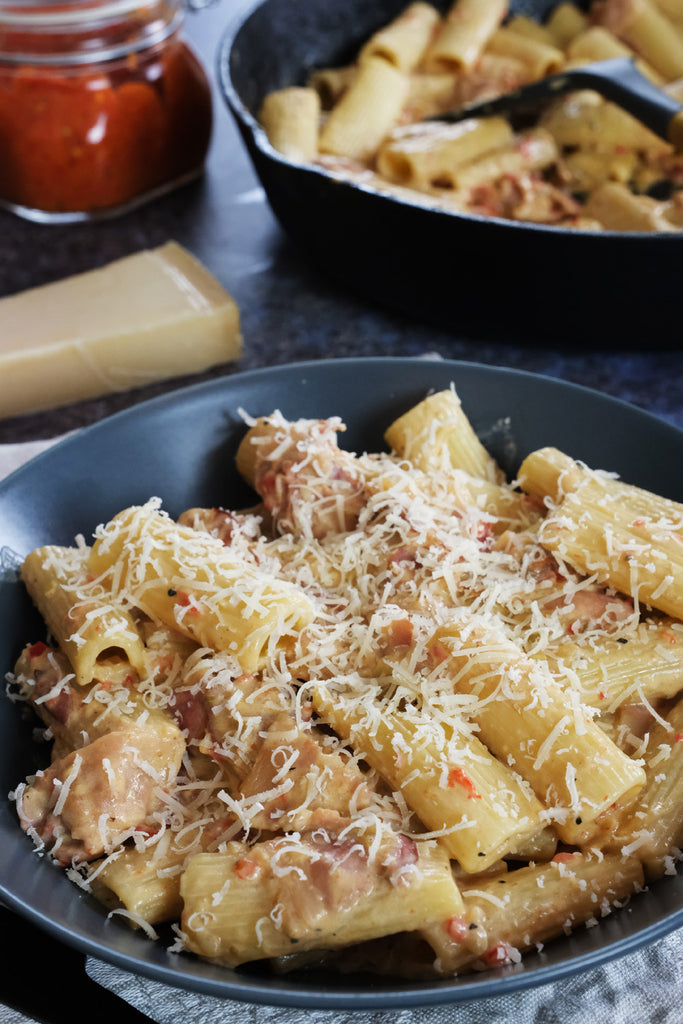 creamy ajvar and bacon pasta served with grated parmesan