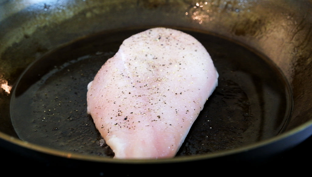 chicken in carbon steel frying pan