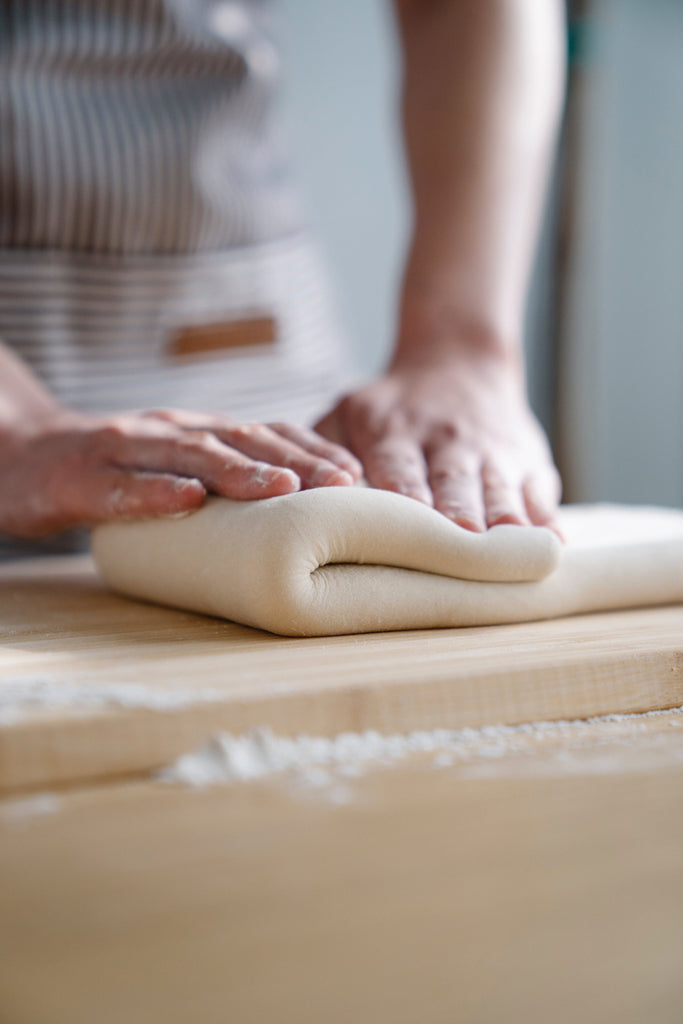 folding dough on the counter