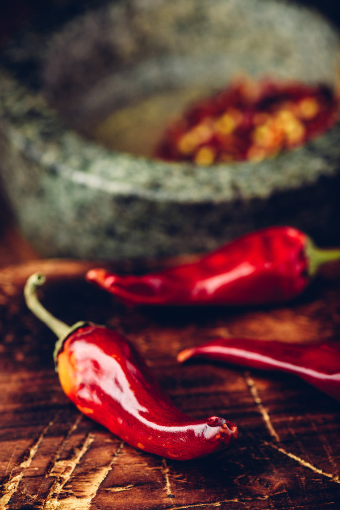 red pepper with a mortar in the background