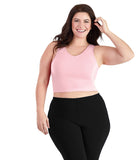 Plus size woman wearing pink JunoActive bra top.