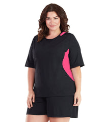 Plus size woman wearing black and pink JunoActive short sleeve rash guard and black swim shorts.