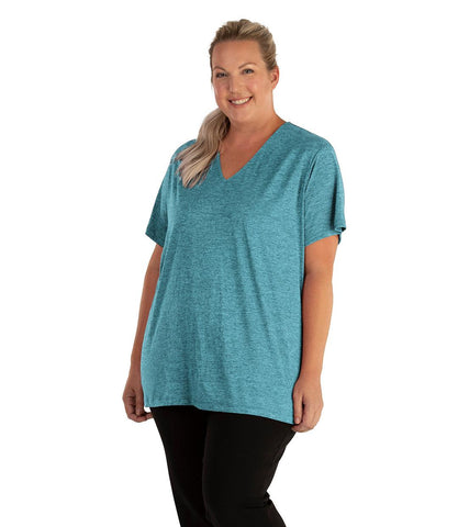 Plus size woman wearing JunoActive turquoise short sleeve tee shirt.