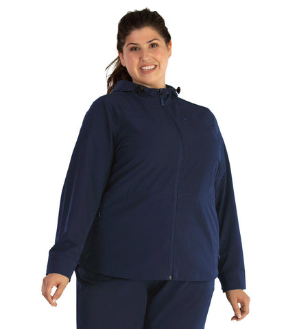 Top half of plus size woman wearing a navy JunoActive hiking and travel jacket.