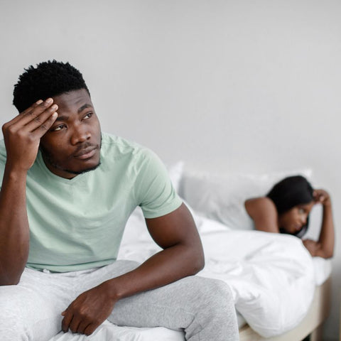 Distressed black couple in bedroom