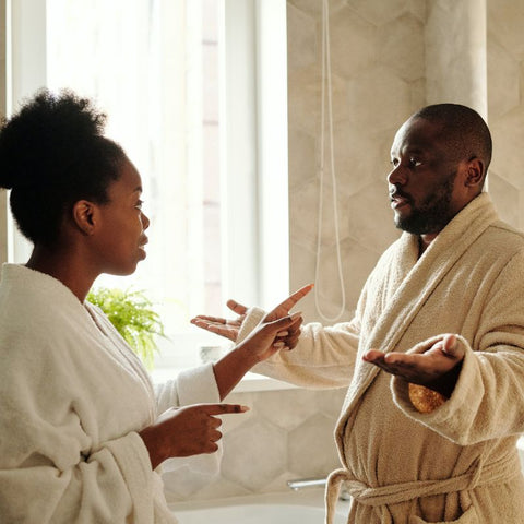 Black couple in bathroom having a discussion about intimacy