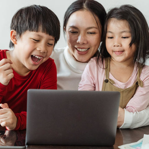 Children with parent reading digital book