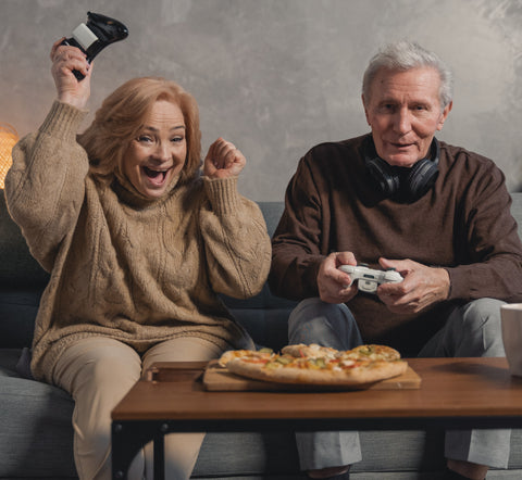 Elderly couple playing video game