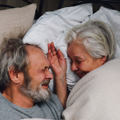 Elderly Couple Sharing Intimate Moment In Bed