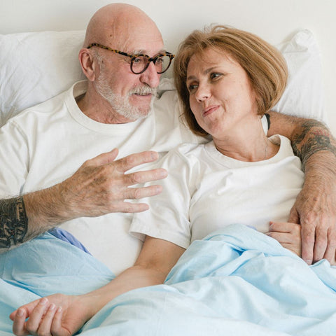 Elderly Couple Sharing Intimate Moment in Bed
