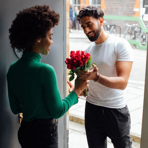 Interracial couple sharing flowers