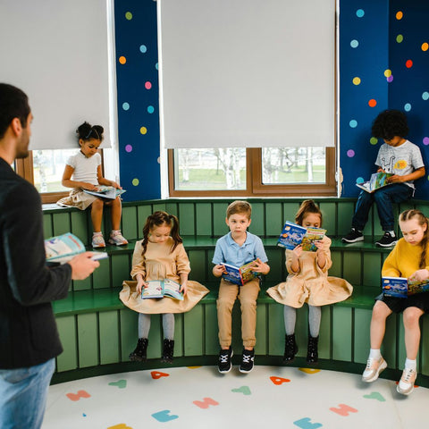 Teacher reading book with children