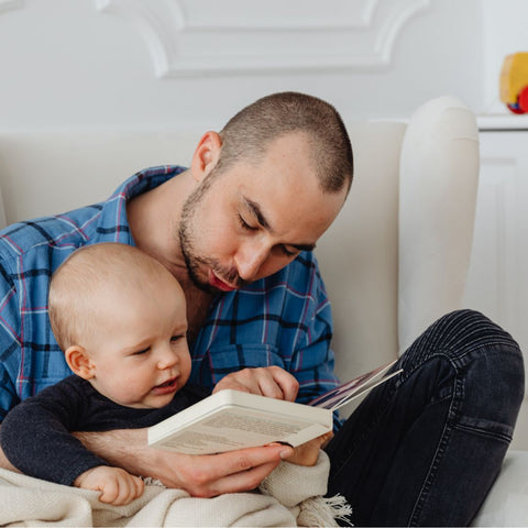 Father reading to daughter