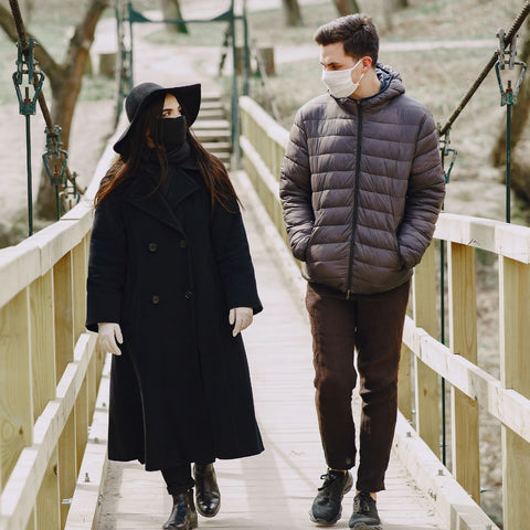 Couple on a stroll while wearing mask to prevent covid spread