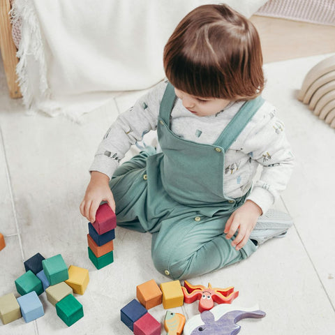 kid playng with building blocks