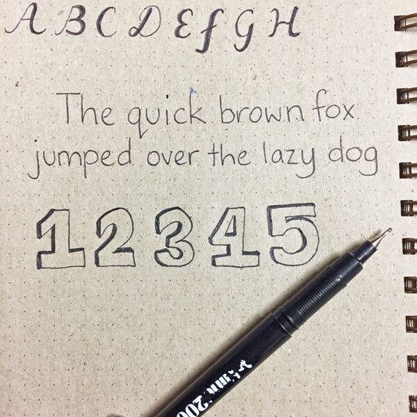 hand lettering practice in notebook