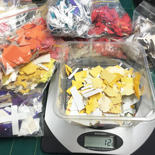 weighing batches of coloured paper scraps
