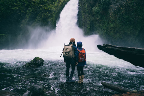 couple hiking at waterfall