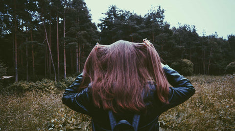 red head walking through forest