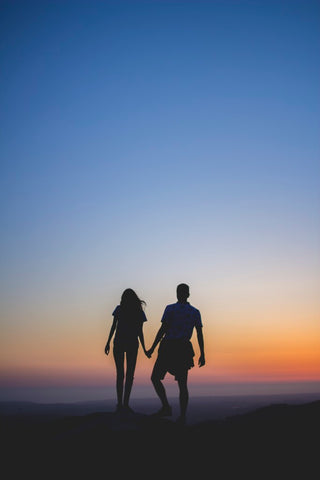 couple walking into sunset