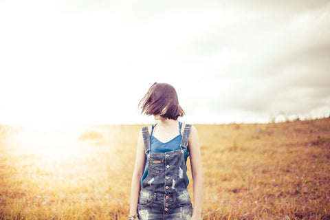 woman with short hair in field