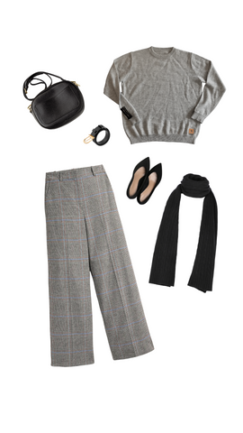 An outfit consisting of a light gray alpaca crew neck sweater, gray plaid dress pants, black flats, purse, belt, and scarf.