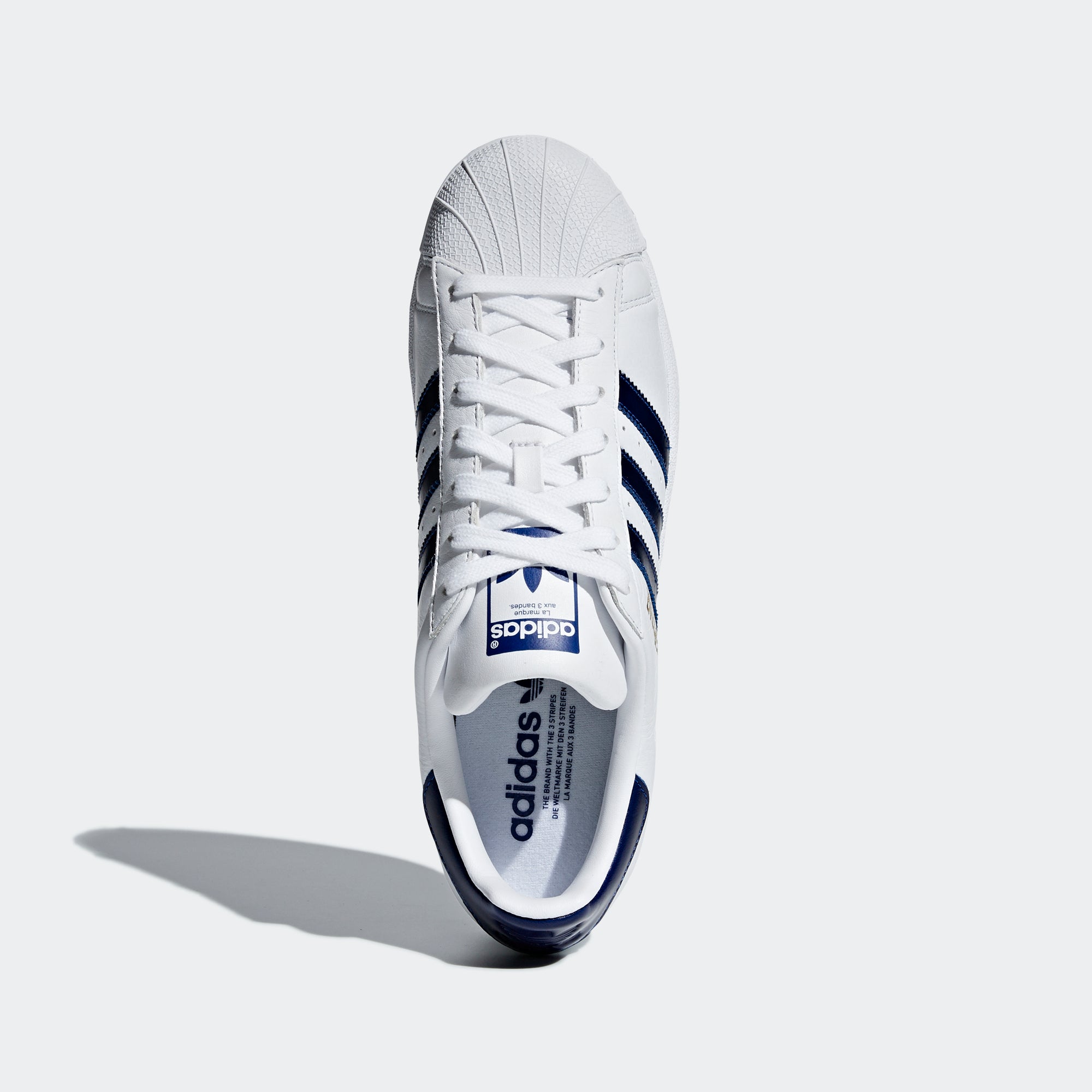 white and navy adidas shoes