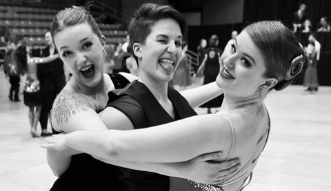 A picture of three friends enjoying a "three-for-all" tango at USA Dance Nationals, an event that Feather Three supports.