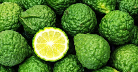 Pile of bergamot fruit with one cut open