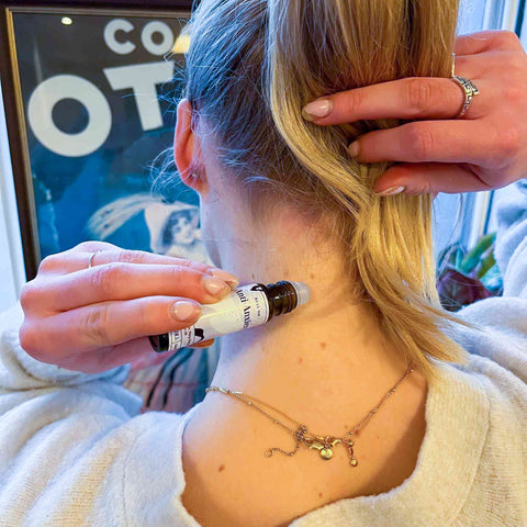 Anti-Anxiety roll on being applied to the back of the neck