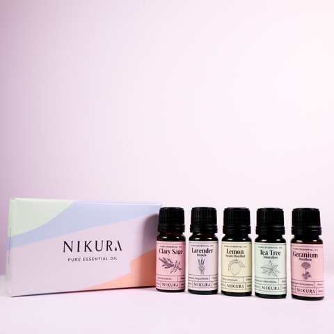 5 x 10ml of essential oil best sellers on a pink background with the gift box