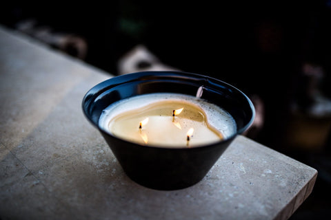 Large candle in a blue bowl with three wicks