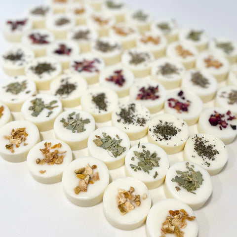 Lots of rows of circular wax melts with various different botanicals in each row