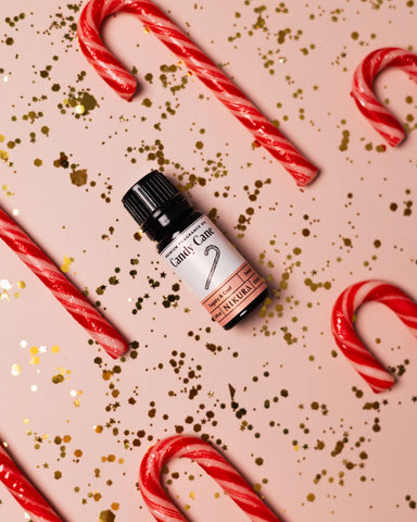 Candy cane fragrance oil surrounded by candy canes